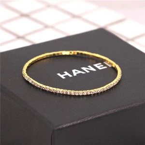 Detail shot of a 2.0mm gold crystal tennis bracelet with single row of sparkling stones