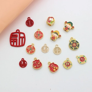 Close-up of red and gold Chinese enamel charms with lucky blessing characters