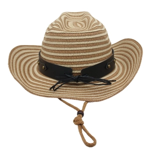 Détail d'un chapeau de cow-boy en paille avec bandeau en cuir noir et rivets en métal