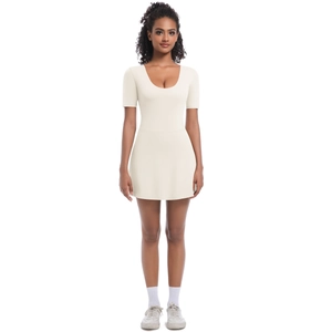 Detail of white short sleeve tennis bodysuit dress with deep U-neck and A-line skirt