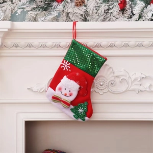 Red felt Christmas stocking with 3D snowman and green sequin tree hanging on a white fireplace
