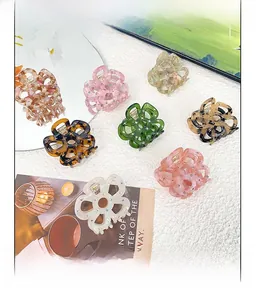 Detail of floral acetate hair claws with rhinestones in multiple elegant pastel colors