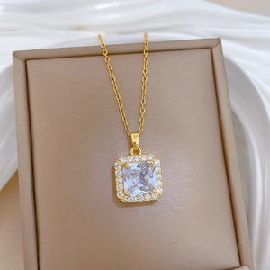 Elegant gold square pendant necklace with micro-paved cubic zirconia on silk background