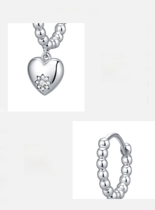 Macro detail of handmade 925 sterling silver heart earrings with sparkling 5A zircon inlay