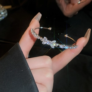 Macro detail of silver bow cuff bracelet featuring sparkling marquise-cut zircon stones