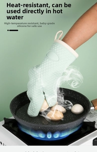 Green heat-resistant silicone glove showing waterproof feature in boiling water