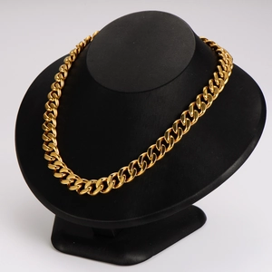 Minimalist gold chunky Cuban chain necklace for men and women on a display stand
