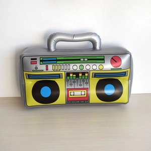 Inflatable retro radio prop with silver and yellow PVC details on a wooden surface