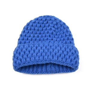 Detailed close-up of chunky knit pattern on a royal blue winter beanie for babies