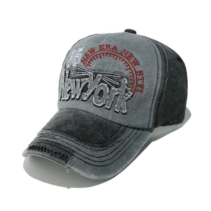 Detail of vintage washed baseball cap with New York patch and worn-out brim effects