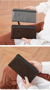 Detail of grey and brown leather passport wallets with elastic straps for secure travel