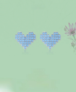 Macro detail of pixel art turquoise heart studs in S925 sterling silver settings