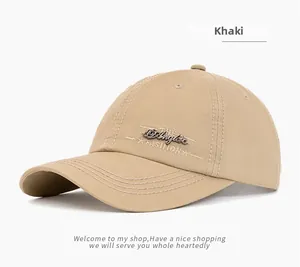 Detail of khaki cotton baseball cap showing the embroidery and curved brim structure