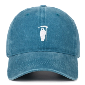 Close-up of white Reaper embroidery on vintage washed blue cotton baseball cap