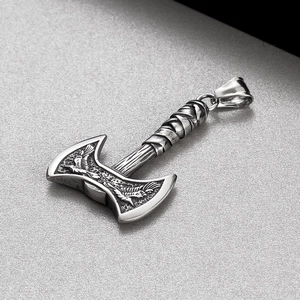 Macro view of stainless steel Viking double-headed axe pendant with embossed eagle patterns