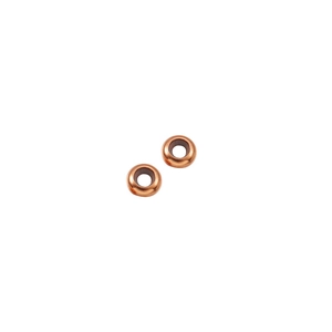 Detailed macro view of two bronze-toned metal spacer beads for DIY jewelry making