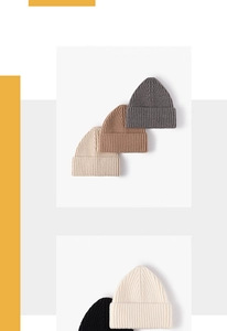 Detailed knit texture of ribbed wool beanies showing thick stitching in various colors