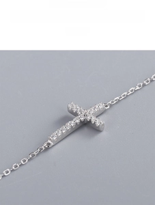 Detailed close-up of S925 silver cross pendant with pavé-set shimmering zircon stones