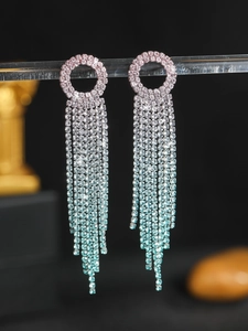 Macro detail of long tassel earrings with pink to blue gradient rhinestones and fringe