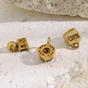 18K gold plated stainless steel barrel beads and zircon charms on white stone