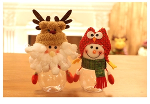 Detail of Christmas reindeer and owl candy jars with knit hats and transparent round bases