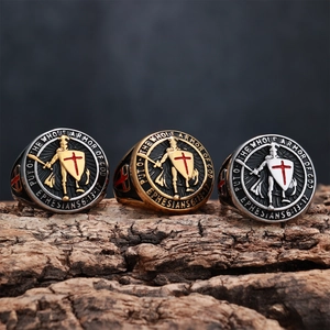 Detailed macro view of three Knight Shield Rings in gold, silver and black on tree bark