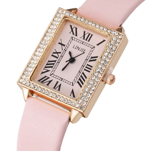 Detail of square rose gold watch with rhinestone bezel and pink leather strap