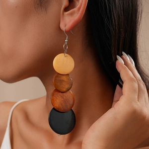 Detail view of Bohemian wood bead earrings worn by a model in a natural light setting