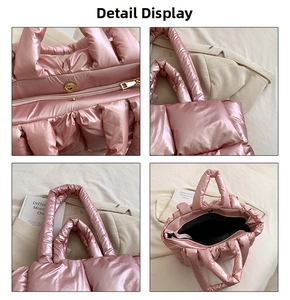 Detail view of pink metallic puffer tote bag with gold zipper and quilted fabric texture