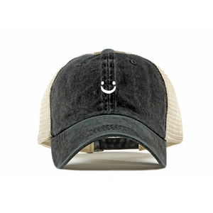 Close-up of a two-tone trucker hat with smiley face embroidery and mesh back