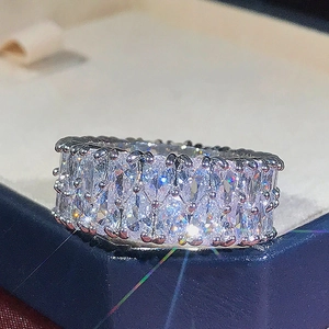 Fashion silver ring with double-row teardrop zircons in a blue velvet jewelry box