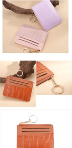 Detail of PU leather card holder with crocodile texture, zipper pocket and gold keychain