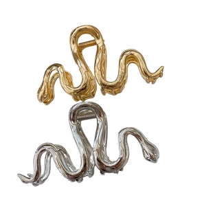 Elegant gold and silver snake-shaped metal hair claws with glossy mirror finish