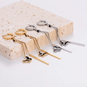 Minimalist butterfly tassel earrings in gold and silver finish on stone display