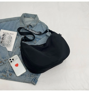 Detail of black waterproof oxford bag with FASHION strap in a casual lifestyle setting