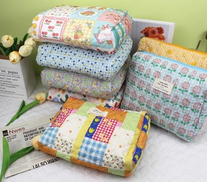 Quilted cotton makeup bags collection featuring floral patterns and vibrant patchwork