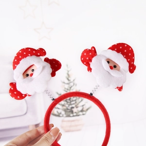 Festive red headband with plush spring-mounted Santa Claus figures for Christmas parties