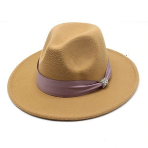Detailed macro view of khaki wool fedora with mauve satin ribbon and rhinestone buckle