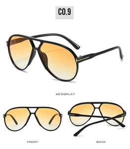 Detail view of pilot sunglasses with yellow gradient lenses and gold T logo accents