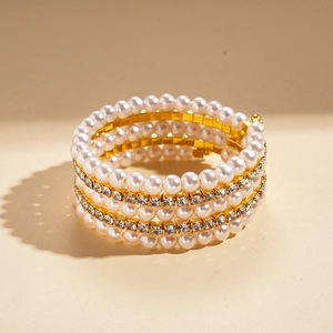 Close-up of luxury multi-layer wrap bracelet with white pearls and sparkling rhinestones