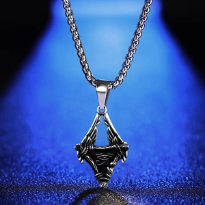 Detailed close-up of stainless steel Eye of Horus winged pendant on a box chain