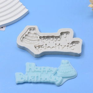 Macro shot of 3-tier cake and Happy Birthday lettering silicone mold for DIY baking