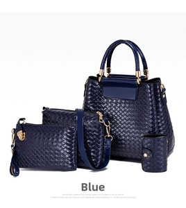 Detail of four-piece set dark blue woven texture handbags with golden metal hardware