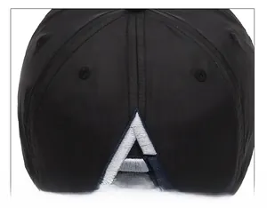 Detail of precise stitching and 3D blue-white letter A embroidery on a black baseball cap