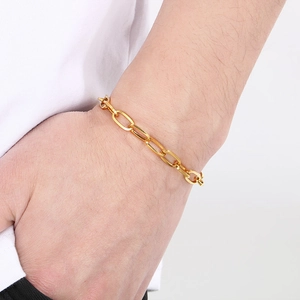 Detailed view of a gold-plated stainless steel oval link chain worn on a wrist