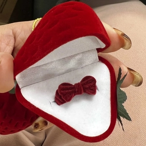 Cute red strawberry shaped velvet jewelry box with a bow ring inside for gifting