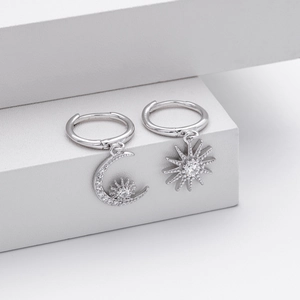 Detail of silver S925 star and moon hoop earrings with pavé cubic zirconia settings