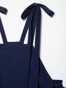 Detail of navy blue pure linen fabric texture and bow strap design on the summer top
