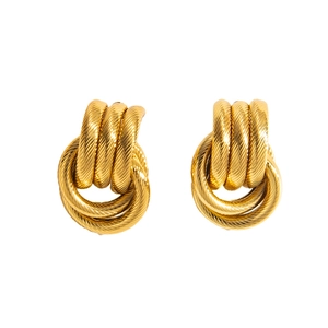 Macro view of gold-tone earrings featuring a spiral multi-layered textured thread design