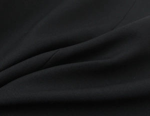 Vue macro détaillée de la texture du tissu textile noir pour les vestes de costume cintrées